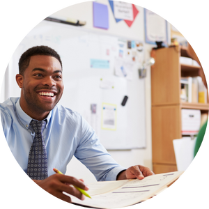 happy male teacher at desk